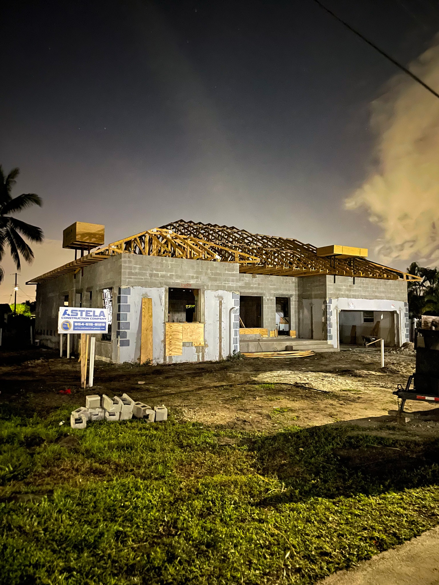 House under construction at night